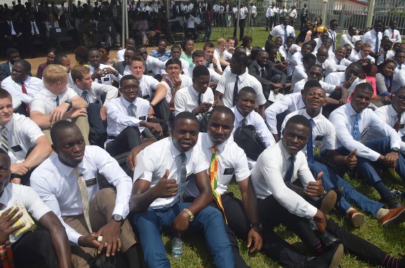 Convidados pelo élder Neil L. Andersen para se aproximarem da cerimônia de abertura de terra, os missionários se reúnem no futuro local do Templo de Abidjan Costa do Marfim em 8 de novembro de 2018.