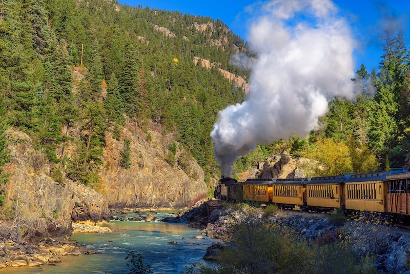 Uma locomotiva de vapor histórica viaja de Durango a Silverton através das Montanhas de San Juan ao longo do Rio Animas no Colorado.