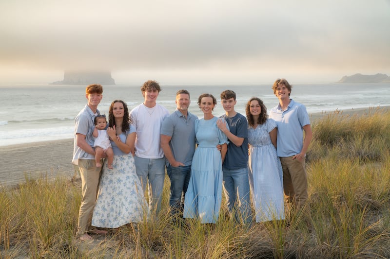 Nove membros da família Anglesey tiram uma foto juntos durante uma viagem a Pacific City, Oregon, em setembro de 2025.