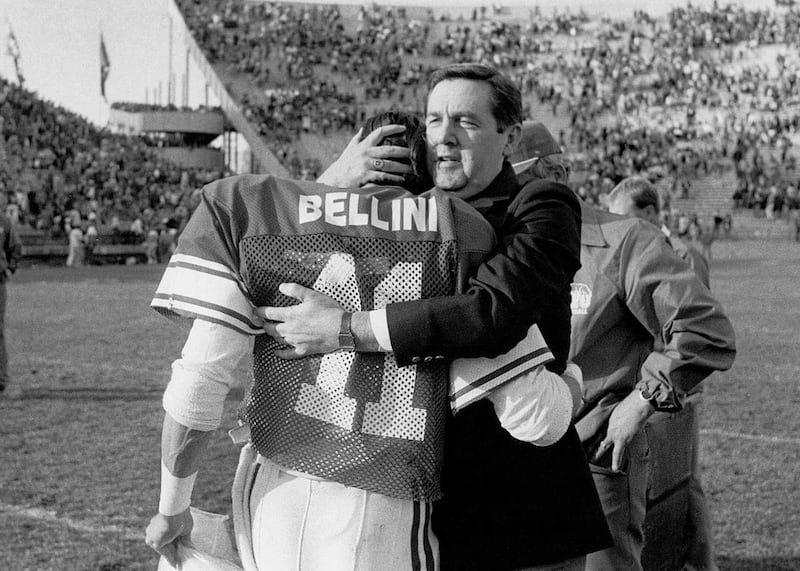 BYU President Jeffrey R. Holland hugs Cougar football player Mark Bellini prior to playing Oregon State University on Nov. 15, 1986, in Provo, Utah.