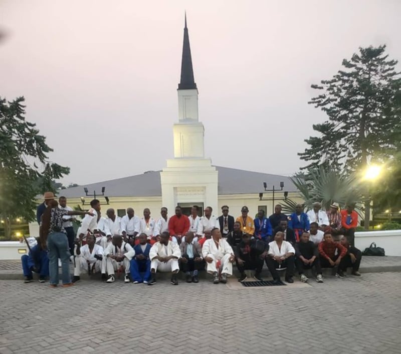 Athletes pause for a photo in front of the Kinshasa Democratic Republic of the Congo Temple during a Word of Wisdom conference in Kinshasa, July 12, 2025.