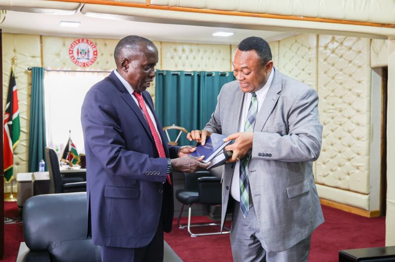Elder Thierry K. Mutombo, Setenta Autoridade Geral e presidente da Área Central da África, presenteia Joseph Ole Lenku, governador do condado de Kajiado, com um Livro de Mórmon em Kajiado, Quênia, em 30 de julho de 2025.