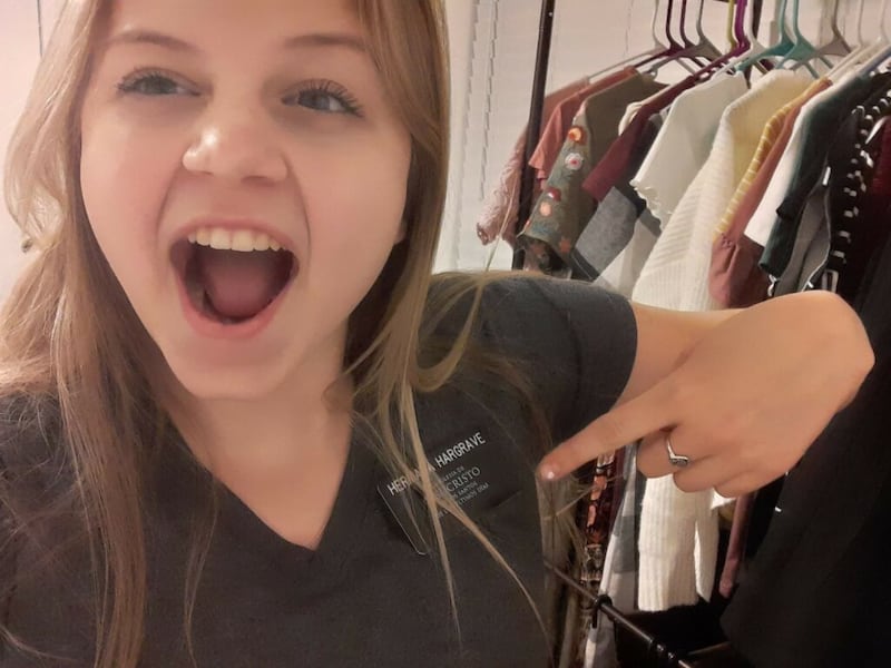 Sister Hannah Hargrave, a new missionary who is training in her own home in San Tan Valley, Arizona, points to her name tag in her room in March 2020.