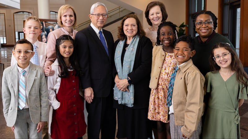 Elder Gerrit W. Gong of the Quorum of the Twelve Apostles, center; his wife, Sister Susan Gong, and the Primary general presidency pose for a photo with children during the filming of the May 2026 Friend to Friend.