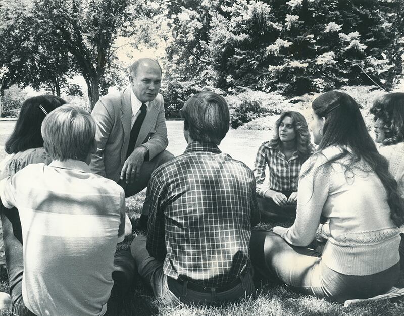 BYU President Dallin H. Oaks, whose administrative tenure ran from 1971 to 1980, speaks with a group of students in this undated photo.