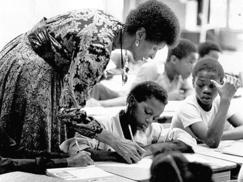 The late Marva Collins, left, assists a student in her classroom. Her life is the subject of "Marva!" — a musical written by Church member John Kunich that tells the real-life story of Collins' commitment to education for all children.