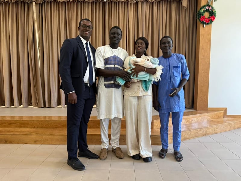 Praia Cape Verde Stake President Leonel da Cruz takes a picture with a family from Nigeria who attend the newly created Praia 6th Branch (English) in Praia, Cape Verde, Sunday, Jan. 25, 2026.