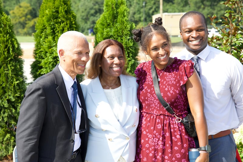 Elder John D. Amos, a General Authority Seventy and member of the Church’s United States Southeast Area presidency, left; and his wife, Sister Michelle Amos, second from left, pose for a picture with guests after the groundbreaking ceremony for the Huntsville Alabama Temple on Saturday, Aug. 15, 2026, in Madison, Alabama.