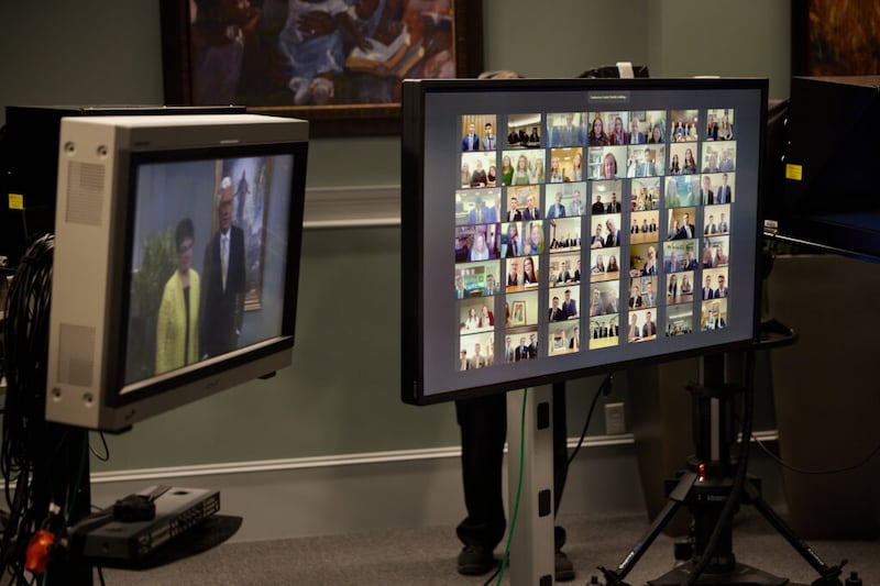 Monitors during the taping of a Feb. 25, 2021, missionary devotional show Elder Dieter F. Uchtdorf and Sister Harriet Uchtdorf conversing with missionaries — shown in videoconference on the screen at right — from the Utah St. George and Washington Spokane missions.
