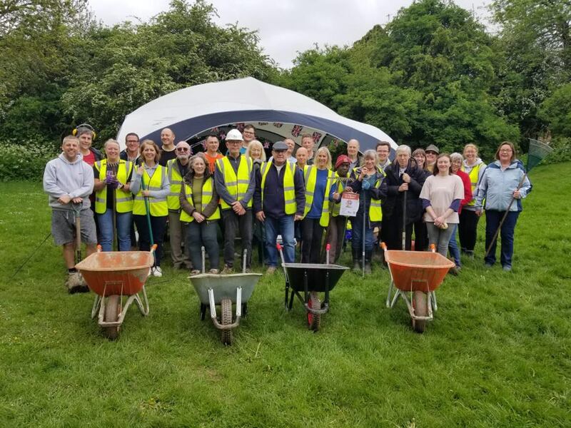 Membros da Estaca Northampton Inglaterra e seus vizinhos movem montes de pedras para criar novos caminhos em um parque em Spinney Hill, Inglaterra, no dia 8 de maio de 2023. Muitos projetos do ServirAgora foram listados para o Big Help Out do Reino Unido naquele dia e nas semanas seguintes.