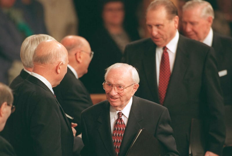 Presidente Gordon B. Hinckley caminha para a última sessão da conferência do domingo à tarde, com o Presidente Thomas S. Monson e o Presidente James E. Faust, em 4 de abril de 1999.