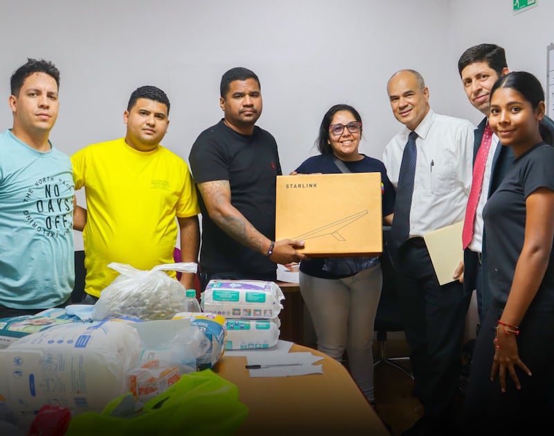 Membros de A Igreja de Jesus Cristo dos Santos dos Últimos Dias posam para uma foto enquanto entregam equipamento de comunicação de emergência a autoridades governamentais em 2 de julho de 2026 em La Guaira, Venezuela.