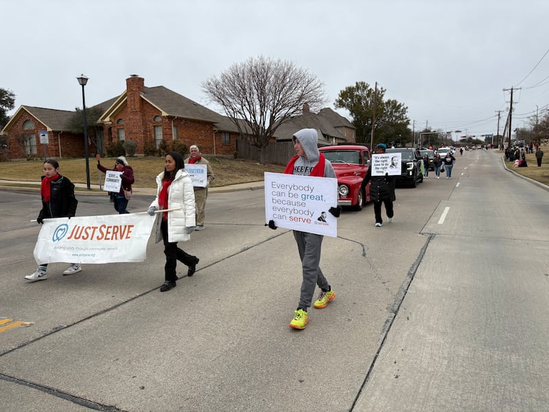 Volunteers walk through Martin Luther King Jr. Day parade on Saturday Jan. 17, 2025 in Carrollton, Texas.