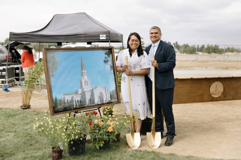 Elder Hutch U. Fale — a General Authority Seventy and member of the Church’s United States West Area presidency — and his wife, Sister Gaylene Fale, stand beside an artist's rendering of the Coeur d’Alene Idaho Temple on the day of its groundbreaking on Saturday, Aug. 29, 2026, in Coeur d’Alene, Idaho.