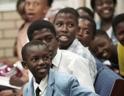 Sinqobile Mkhize e outros jovens assistem ao Élder Ronald A. Rasband, do Quórum dos Doze Apóstolos de A Igreja de Jesus Cristo dos Santos dos Últimos Dias, enquanto fala durante um devocional para a juventude do Templo de Durban África do Sul, em Durban, África do Sul, no sábado, dia 15 de fevereiro, 2020. (Nota: Esta imagem foi tirada antes da pandemia de COVID-19 e não reflete as atuais precauções de distanciamento social).