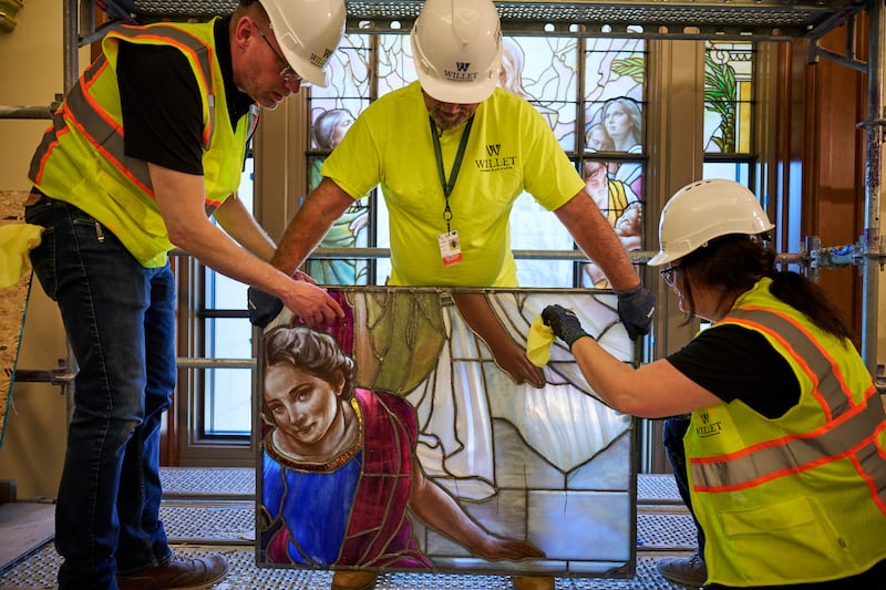 Equipes colocam meticulosamente painéis de vidro artístico nos edifícios da entrada norte na Praça do Templo em Salt Lake City na quarta-feira, 11 de março de 2026.