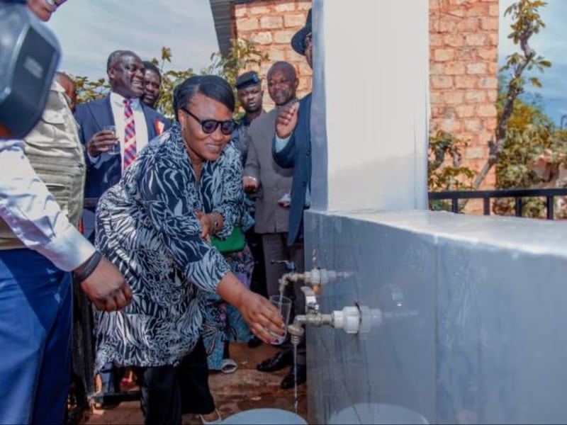 Deputy Mayor Farida Mwepu Oduel fills her glass with water from the new water well following the symbolic inauguration ceremony in Kolwezi, Democratic Republic of the Congo, May 15, 2026.