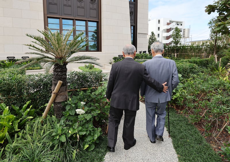 Kensei Nagamine e Akira Yafuso, líderes pioneiros em Okinawa, caminham pelo jardim do Templo de Okinawa Japão, em Okinawa, na sexta-feira, 10 de novembro de 2023.