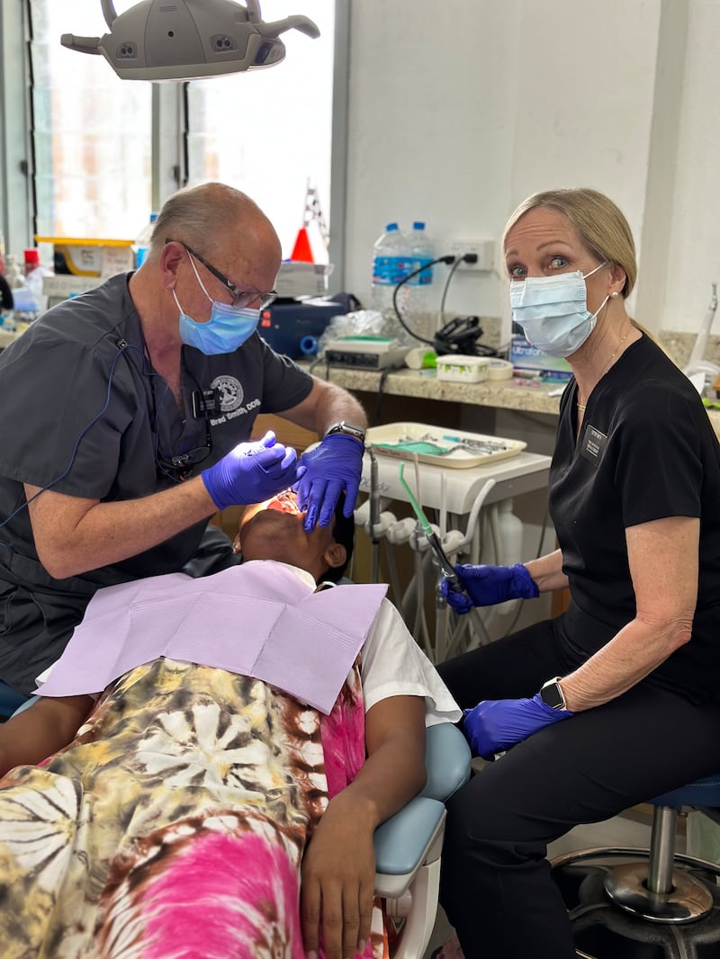 Elder Brad Smith e Sister Sherrie Smith trabalham nos dentes de um paciente na clínica odontológica Moroni em Eita, Kiribati, julho de 2024.