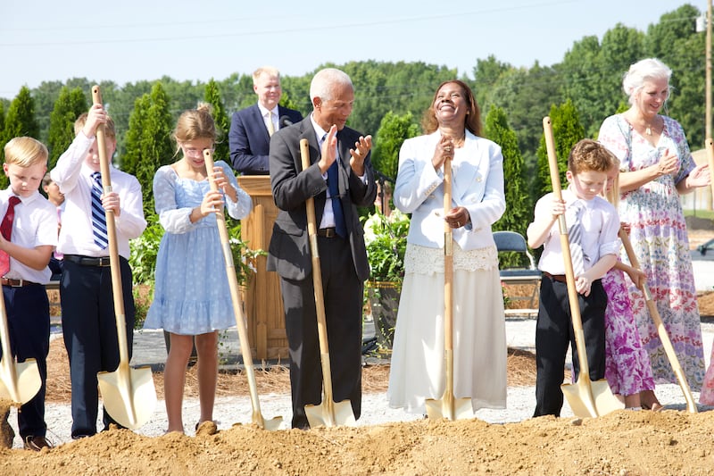 Elder John D. Amos, a General Authority Seventy and member of the Church’s United States Southeast Area presidency, fourth from right; and his wife, Sister Michelle Amos, third from right, join others in breaking ground for the Huntsville Alabama Temple on Saturday, Aug. 15, 2026, in Madison, Alabama.