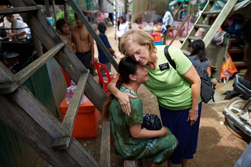 Uma missionária sênior abraça uma mulher no Camboja em 2024.