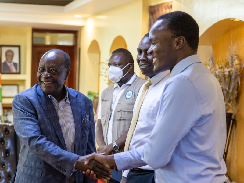 Wilber Ottichilo, Governor of Vihiga County, Kenya, left, shakes hands with Denis Mukasa, Africa Central Area humanitarian manager, right, May 21, 2026.